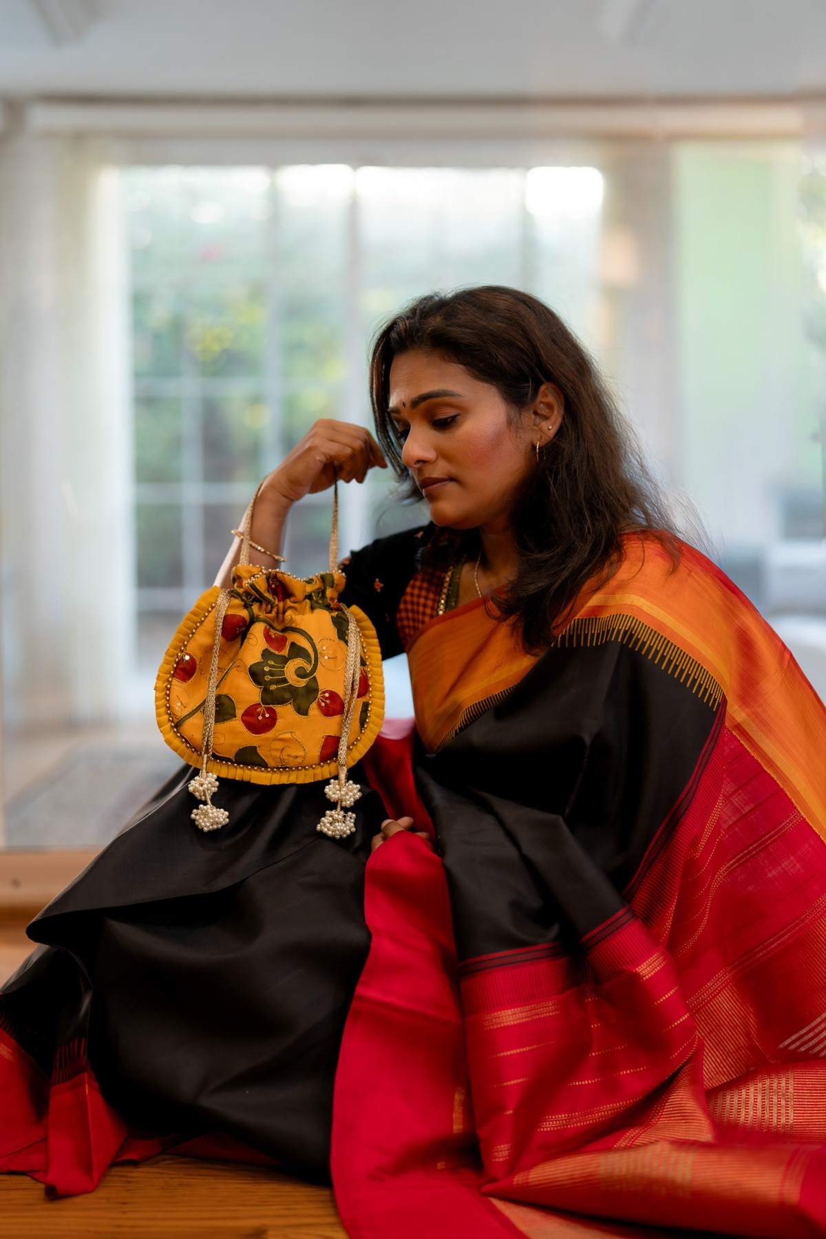 A closer look at the yellow potli paired with a black blouse