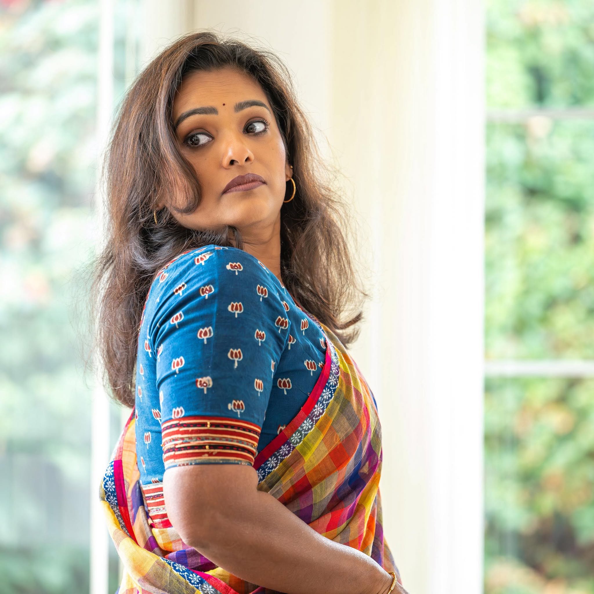 Subha in a blue lotus-print blouse paired with a multicolour checked saree