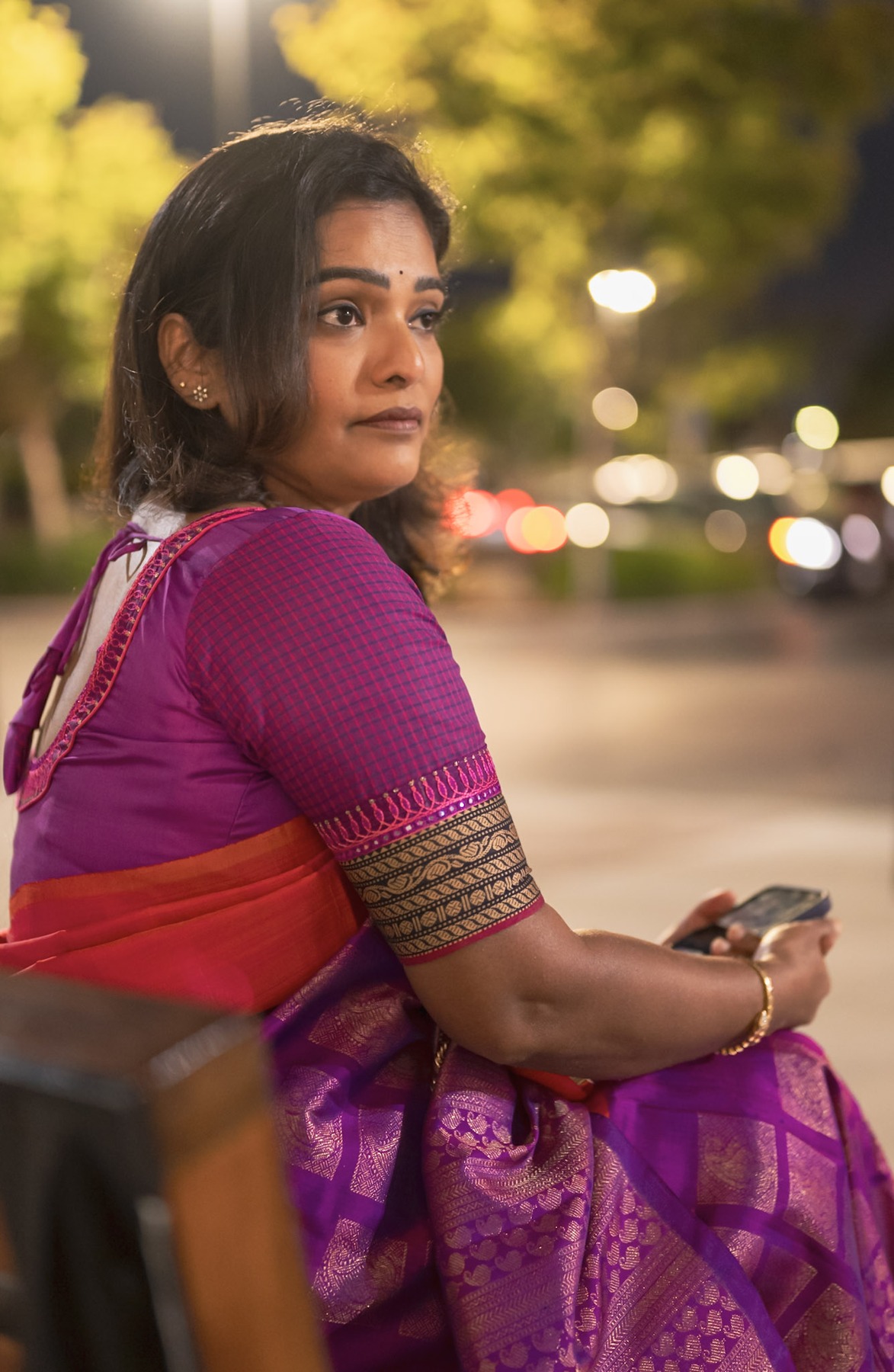 Back view of a purple checked blouse paired with an orange and purple saree