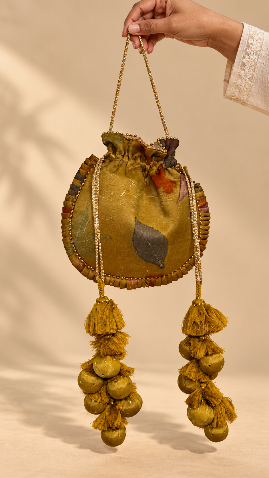 Mustard Kanchi Eco-print Potli — carrying view