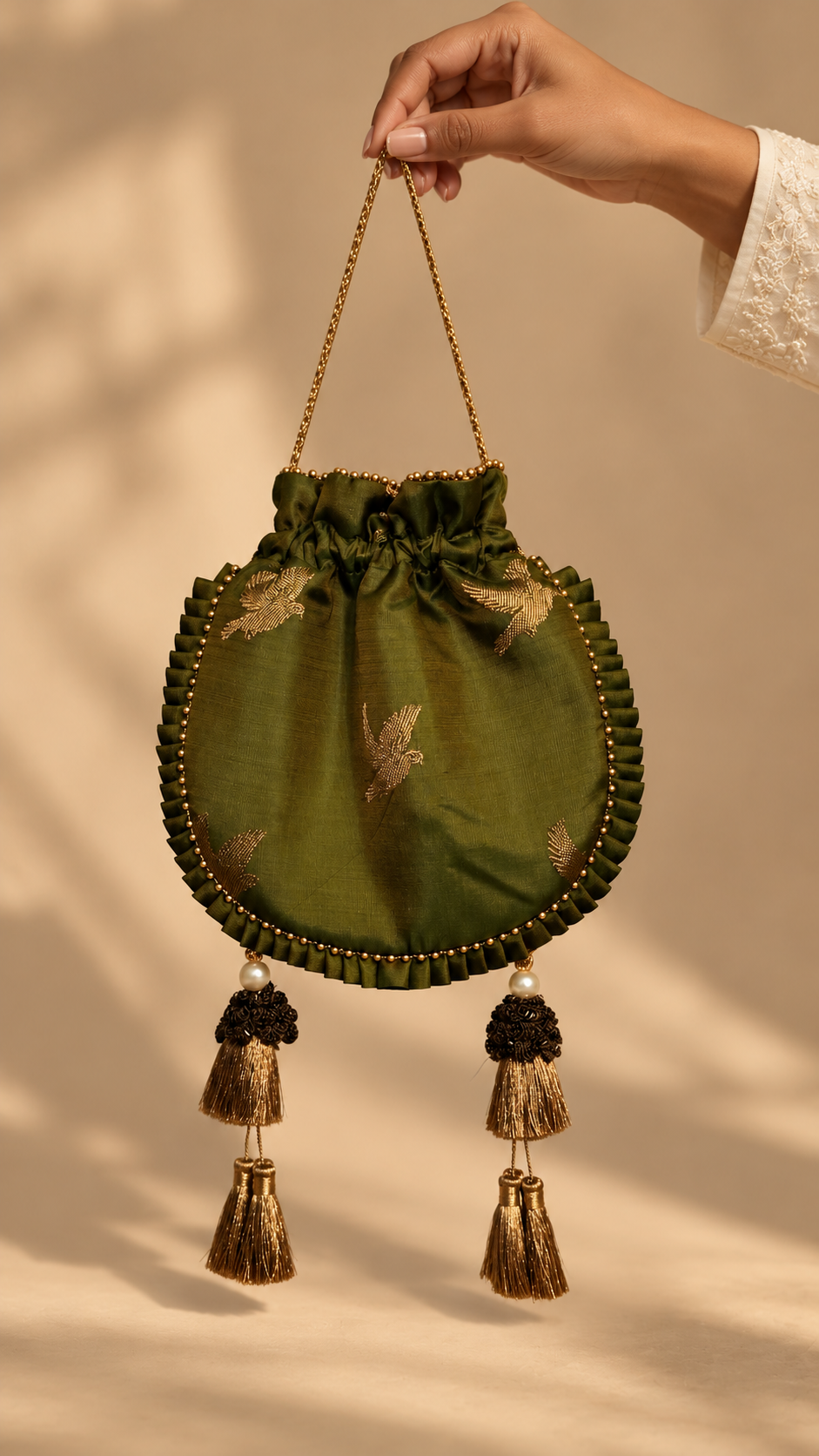 Olive Green Flying Bird Potli — carrying view